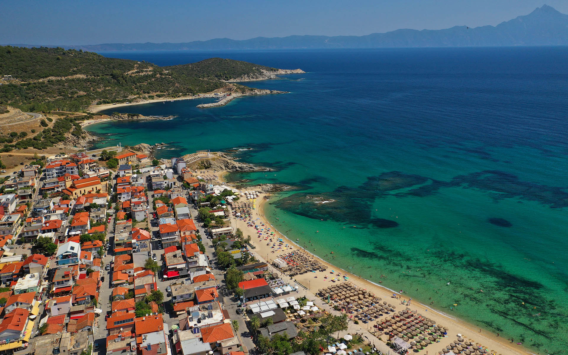Aerial drone photo of famous village and long sandy beach of Sarti in South Sithonia peninsula, Halkidiki, Greece